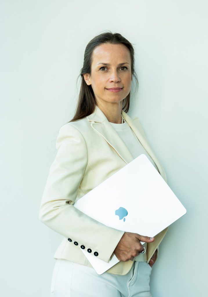 Silvia Púchovská, founder of Studio Inbound, holding a laptop.